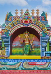 Indian traditional Goddess Mariyamman statue on temple tower	
