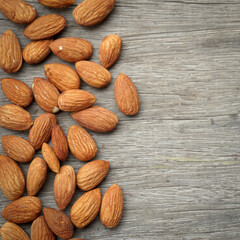Almonds nuts on an old wood background