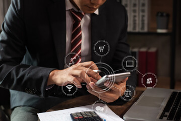 Social media and Marketing virtual icons screen of business businessman typing keyboard with smart phone and laptop computer at office.