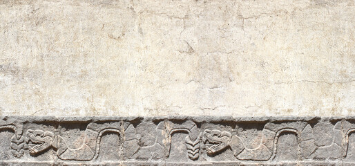 Grunge background with stone wall texture and bas-relief carving of a snake