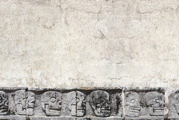Horizontal banner with stone wall texture and bas-relief carving with human skulls