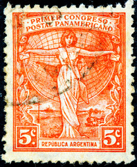 a woman holding letters in front of a globe and promotes 1st Pan-American Postal Congress in Buenos Aires.