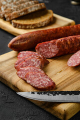 Closeup view of smoked pork sausage rings on wooden cutting board