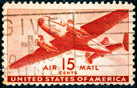 US Air Mail postage stamp depicting an illustration of a vintage transport plane