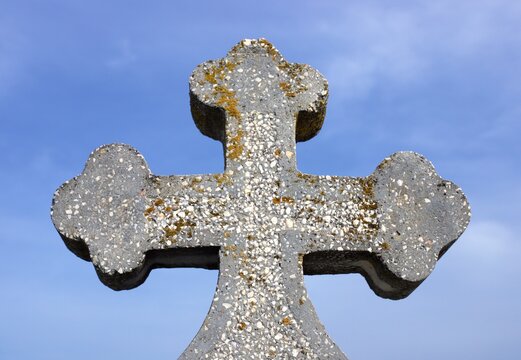 a concrete cross on a blue sky background