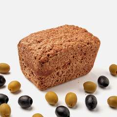 small rye bread on a white plate with olives