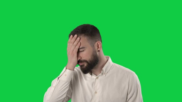 Annoyed business man making facepalm fail gesture. Portrait on green screen background.