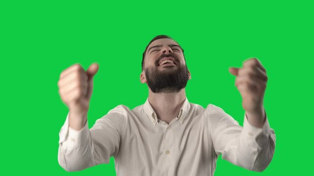 Young businessman fan watching game score or goal reaction. Portrait on green screen background.