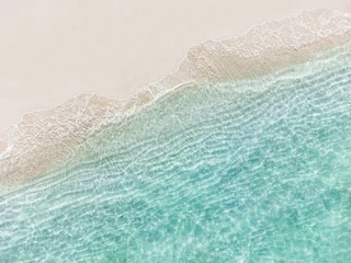 Poster Im Rahmen Aerial top view of beautiful tropical white sand beach with wave foam and transparent sea, Summer vacation and Travel background with copy space, Top view from drone © Kittiphan