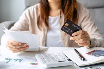 Stressed young woman calculating monthly home expenses, taxes, bank account balance and credit card bills payment, Income is not enough for expenses