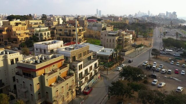 Aerial Shot Of Houses By Street In City During Sunset, Drone Flying Forward Over Residential Structures - Jaffa, Israel