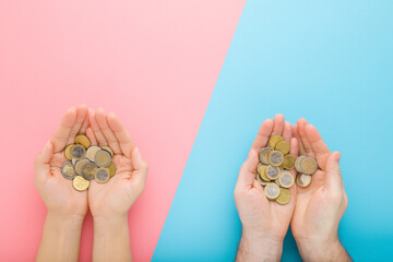 Opened young adult man and woman palms with euro coins on light blue pink table background. Pastel color. Point of view shot. Closeup. Compare income between husband and wife. Top down view. - obrazy, fototapety, plakaty