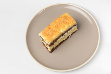 A piece of a layered cake with sour cream. Traditional recipe of Smetannik, sweet cream cake.