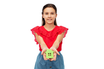 eco living, environment and sustainability concept - smiling little girl holding green house icon over white background