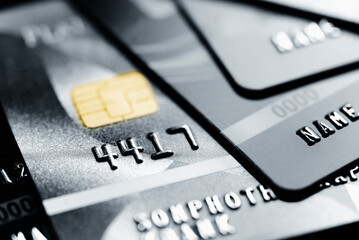 Stack credit cards, close up view with selective focus for background. Online credit card payment.