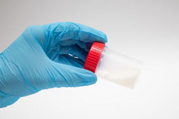 Doctor holding a plastic jar with sperm for semen analysis. Medical test in hospital. Semen analysis in a Bank. Sample sperm. Donor Sperm. Man health concept