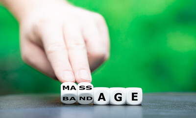 Symbol for having a massage instead of a bandage. Hand turns dice and changes the word "bandage" to "massage".
