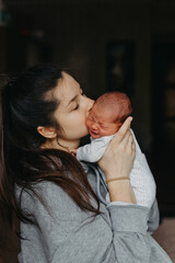 home photos of a newborn baby in the arms of mother. Selective focus, noise effect