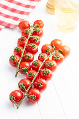 Fresh red cherry tomatoes. Small tomatoes on branch.