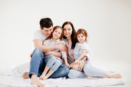 beautiful happy family cuddling in a white photo studio. backstage.