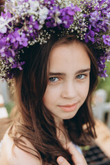 Naklejka premium Cute 13-year-old child girl carrying basket of beautiful flower in the flower field with happiness