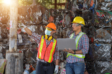 Recycling industry a worker who recycling thing on recycle center.Manager and Manual Worker in Metal Landfill