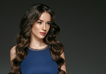 Beautiful woman in evening dress with long brunette hairstyle