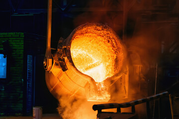 Metal Casting process in Foundry, Molten Iron pours from ladle to Blast Furnace.