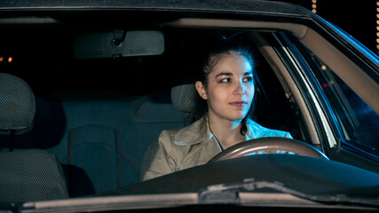 Girl driving car at night