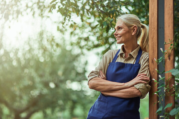 Smiling middle aged caucasian business woman in garden