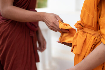 The monk is wearing the robe to the newly ordained monks in the temple, during the Buddhist...