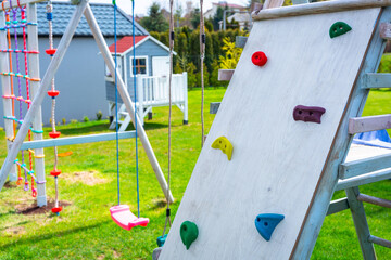 Garden playground for children with a climbing wall