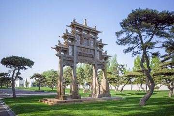 Obraz premium traditional archway building and pine tree in the garden