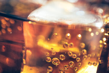 Refreshing Bubbly Soda Pop with Ice Cubes. Cold soda iced drink in a glasses - Selective focus,...