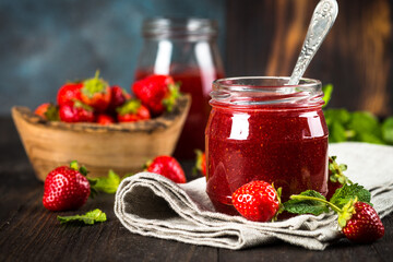 Strawberry jam in the glass jar.