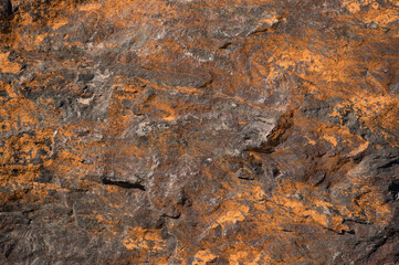 Chipped rock with orange inclusions and impurities. Background