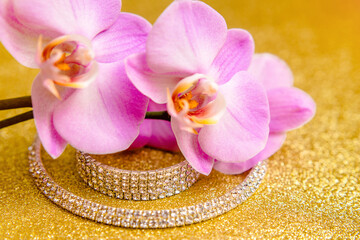 Bracelet and necklace on a gold shiny background
