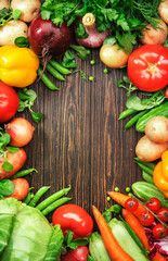Healthy food. Assortment of fresh summer organic vegetables and herbs on wooden table background