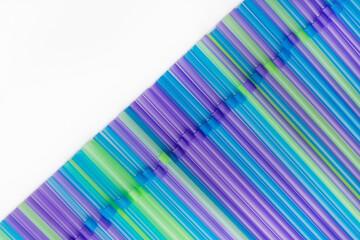 Colorful background from plastic straws for drinks, bar accessories. The current trend towards...