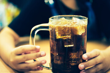 Refreshing Bubbly Soda Pop with Ice Cubes. Cold soda iced drink in a glasses - Selective focus,...