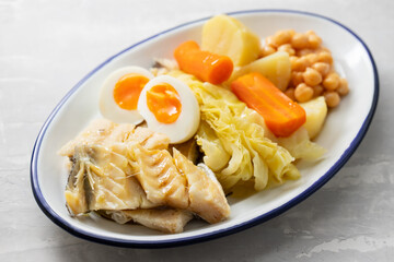 boiled cod fish with boiled vegetables on dish