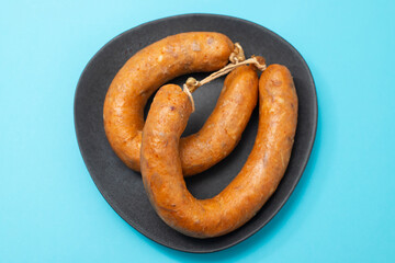 typical portuguese smoked sausage alheira on dark dish
