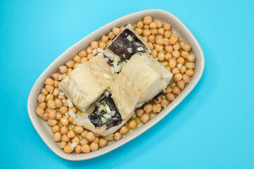 boiled cod fish with chick-pea on the dish