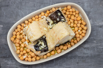 boiled cod fish with chick-pea on the dish