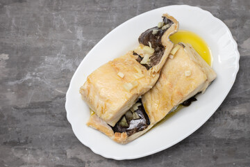 boiled cod fish with olive oil on white dish