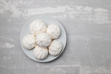 sweets on white plate on ceramic background