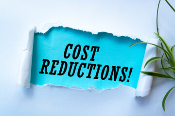 Cost Reductions words on copybook page. Production or reselling Business concept for reduction expenses for goods and services.