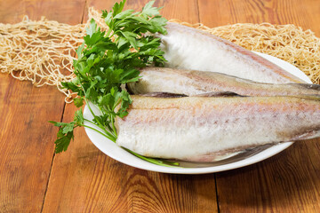 Alaska pollock carcasses on old rustic table with fishing net
