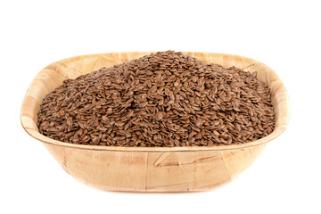 Flax seeds in a wooden bowl over a white background.
