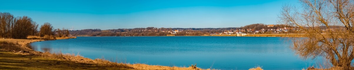 Fototapeta premium High resolution stitched panorama of a beautiful sunny winter view at the famous Vilstal lake near Reisbach, Bavaria, Germany